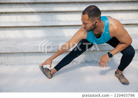 Male athlete doing legs workout and squats on the stairs Male athlete doing legs workout and squats on the stairs 110403796