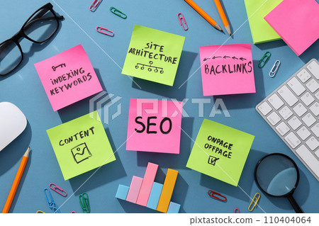 Notes, stationery, keyboard and glasses on blue background, top view 110404064