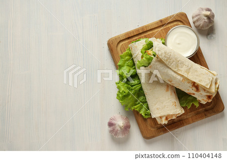 Tasty fast or homemade food concept - delicious shawarma Tasty fast or homemade food concept - delicious shawarma 110404148