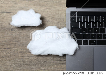 A white cloud made of cotton wool on a laptop keyboard A white cloud made of cotton wool on a laptop keyboard 110404472