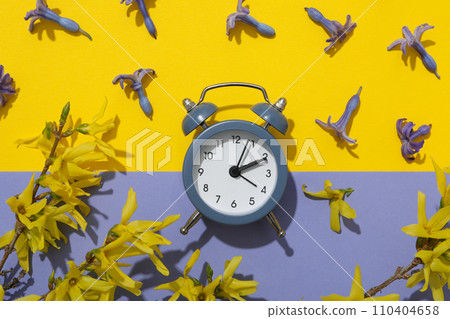 Blue classic alarm clock with fresh flowers Blue classic alarm clock with fresh flowers 110404658