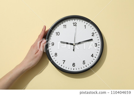 A round clock on a light background A round clock on a light background 110404659