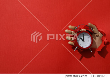 Red alarm clock on a red background Red alarm clock on a red background 110404660