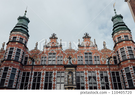 View of the Great Armoury building in Gdansk. The building is richly decorated. There building has many spikey towers. Renaissance building View of the Great Armoury building in Gdansk. The building is richly decorated. There building has many spikey towers. Renaissance building 110405720