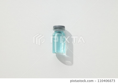 Glass medical bottle with vaccine on white background, top view 110406873