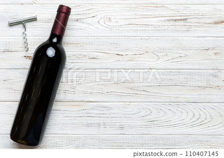 One Bottle of red wine with corkscrew on colored table. Flat lay, top view wth copy space One Bottle of red wine with corkscrew on colored table. Flat lay, top view wth copy space 110407145