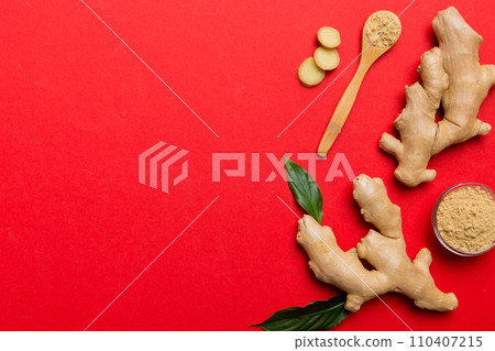 Finely dry Ginger powder in bowl with green leaves isolated on colored background. top view flat lay Finely dry Ginger powder in bowl with green leaves isolated on colored background. top view flat lay 110407215