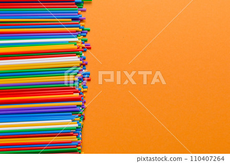 Heap of colorful plastic drinking straws on Colored background, flat lay. Copy Space for text Heap of colorful plastic drinking straws on Colored background, flat lay. Copy Space for text 110407264