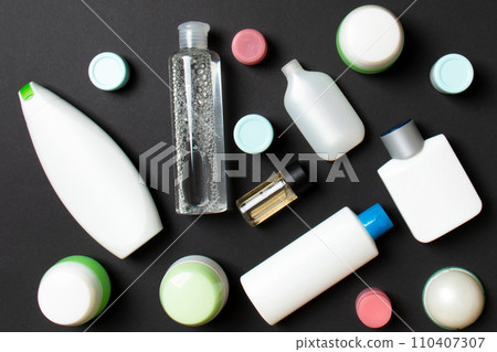 Close-up set of diffrent sized bottles and jars for cosmetic products on colored backgound. Face and body care concept with copy space 110407307