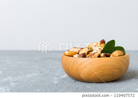 Fresh healthy Brazil nuts in bowl on colored table background. Top view Healthy eating bertholletia concept. Super foods 110407572