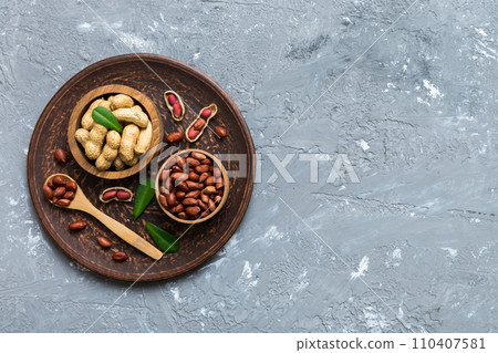 Fresh healthy peanuts in bowl on colored table background. Top view Healthy eating bertholletia concept. Super foods 110407581