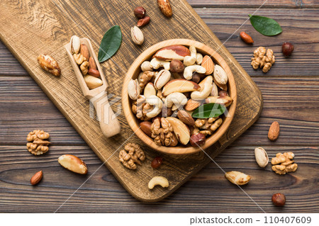 mixed nuts in bowl. Mix of various nuts on colored background. pistachios, cashews, walnuts, hazelnuts, peanuts and brazil nuts mixed nuts in bowl. Mix of various nuts on colored background. pistachios, cashews, walnuts, hazelnuts, peanuts and brazil nuts 110407609