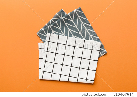 top view with white empty kitchen napkin isolated on table background. Folded cloth for mockup with copy space, Flat lay. Minimal style top view with white empty kitchen napkin isolated on table background. Folded cloth for mockup with copy space, Flat lay. Minimal style 110407614