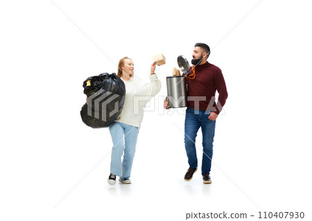 Young man and woman taking care environmental cleaning, taking garbage away isolated over white background Young man and woman taking care environmental cleaning, taking garbage away isolated over white background 110407930