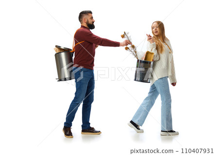 Man putting dry flowers in trash bin. Young people, man and woman taking care after planet, cleaning isolated over white background Man putting dry flowers in trash bin. Young people, man and woman taking care after planet, cleaning isolated over white background 110407931