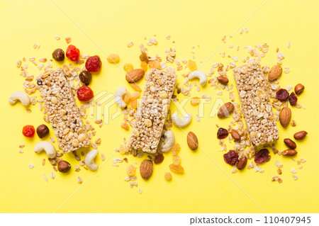 Various granola bars on table background. Cereal granola bars. Superfood breakfast bars with oats, nuts and berries, close up. Superfood concept Various granola bars on table background. Cereal granola bars. Superfood breakfast bars with oats, nuts and berries, close up. Superfood concept 110407945