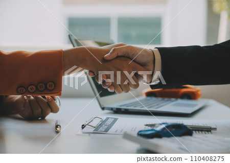 Closeup asian male people car salesman or sales manager offers to sell a car and explains and reads the terms of signing a car contract and insurance. 110408275