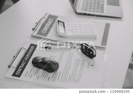 Closeup asian male people car salesman or sales manager offers to sell a car and explains and reads the terms of signing a car contract and insurance. 110408295