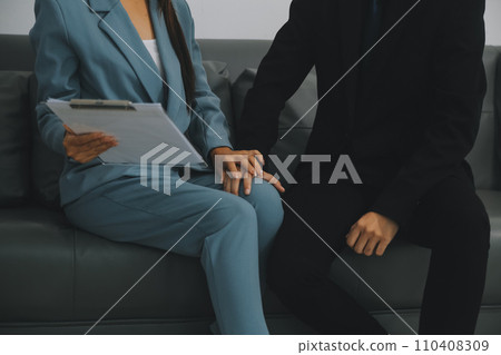 Sexsual harassment in workplace. Unhappy female employee looking at hand of boss touch at her shoulder and feeling disgusted. Sexsual harassment in workplace. Unhappy female employee looking at hand of boss touch at her shoulder and feeling disgusted. 110408309
