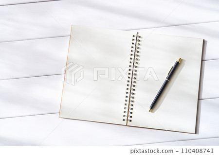 Open plain ring notebook and ballpoint pen 110408741