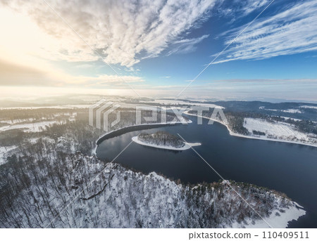Sec water reservoir with small forested island in the middle. Iron Mountains, Czechia. Aerial view from drone. 110409511