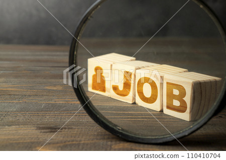 The magnifying glass focuses on wooden cubes with Job text and a male figure The magnifying glass focuses on wooden cubes with Job text and a male figure 110410704