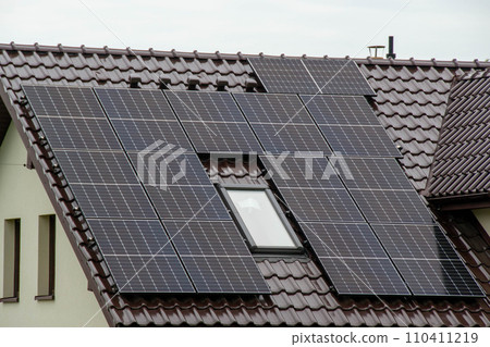 Historic farm house with modern solar panels on roof and wall Illustration 110411219