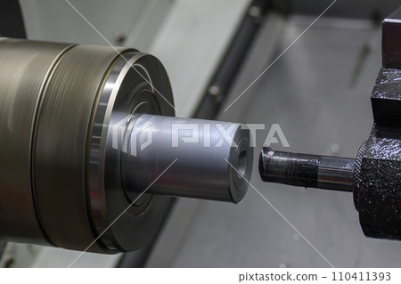The  CNC lathe machine bore  cutting the metal shaft parts. 110411393