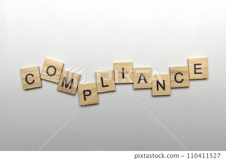 A row of wooden cubes with compliance letters 110411527