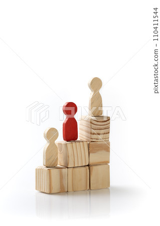 Wooden figures standing on wooden cube stairs 110411544