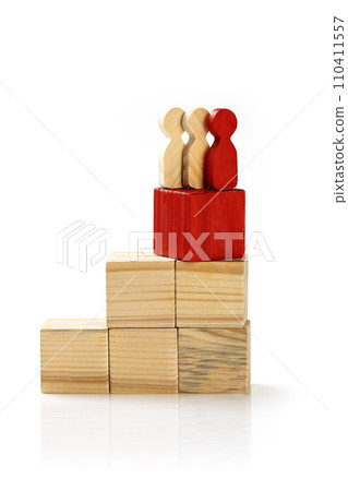 Wooden figures standing on wooden cube stairs Wooden figures standing on wooden cube stairs 110411557