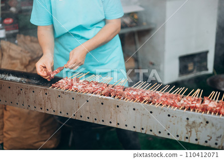 Focus selection: Pork grilled vendors, street food available in Thailand. Hand of a hawker grilled pork and beef over an open fire. Selling traditional hot food at the Fair Focus selection: Pork grilled vendors, street food available in Thailand. Hand of a hawker grilled pork and beef over an open fire. Selling traditional hot food at the Fair 110412071