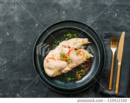 Sous Vide Chicken with spices. Boiled chicken sous-vide on black plate. Sous-vide is culinary method of long-term cooking 110412100