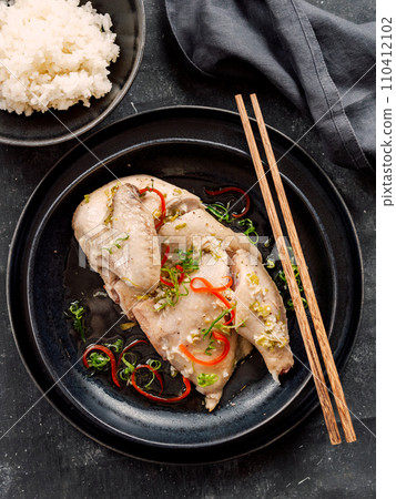 Sous Vide Chicken with spices. Boiled chicken sous-vide on black plate. Sous-vide is culinary method of long-term cooking 110412102