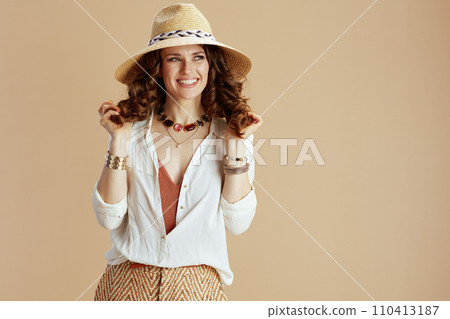 happy woman in blouse and shorts against beige happy woman in blouse and shorts against beige 110413187