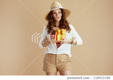 pensive elegant female in blouse and shorts on beige pensive elegant female in blouse and shorts on beige 110413190