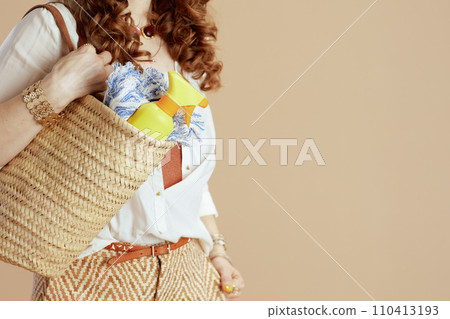 Stylish woman in blouse and shorts on beige Stylish woman in blouse and shorts on beige 110413193