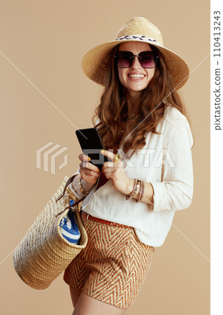 smiling elegant woman in blouse and shorts isolated on beige smiling elegant woman in blouse and shorts isolated on beige 110413243