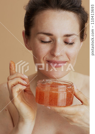 happy modern 40 years old woman with face scrub happy modern 40 years old woman with face scrub 110413693