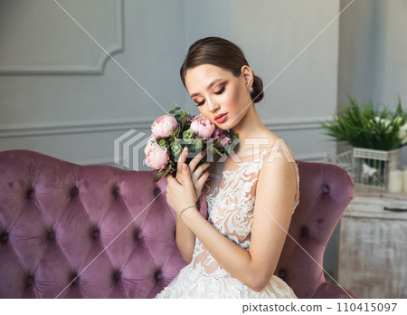 Gorgeous bride posing in white wedding dress, makeup, jewelry, bouquet Gorgeous bride posing in white wedding dress, makeup, jewelry, bouquet 110415097