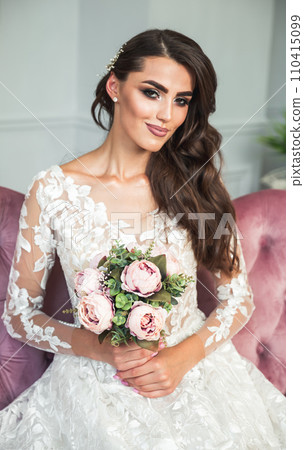 Pretty young bride in white wedding dress holding a bridal bouquet Pretty young bride in white wedding dress holding a bridal bouquet 110415099