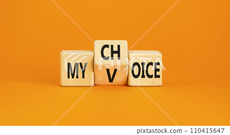 My voice choice symbol. Businessman turns wooden cubes and changes the concept word My choice to My voice. Beautiful orange table orange background, copy space. Business and my voice choice concept 110415647