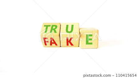Fake or true symbol. Turned wooden cubes and changed the word fake to true or vice versa. Beautiful white table, white background, copy space. Business and fake or true concept. Fake or true symbol. Turned wooden cubes and changed the word fake to true or vice versa. Beautiful white table, white background, copy space. Business and fake or true concept. 110415654