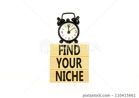 Find your niche symbol. Concept words Find your niche on wooden blocks. Black alarm clock. Beautiful white table white background. Business and find your niche concept. Copy space. 110415661