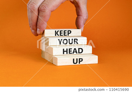 Keep your head up symbol. Concept words Keep your head up on wooden cubes. Beautiful orange table orange background. Businessman hand. Business motivational keep your head up concept. Copy space. Keep your head up symbol. Concept words Keep your head up on wooden cubes. Beautiful orange table orange background. Businessman hand. Business motivational keep your head up concept. Copy space. 110415690
