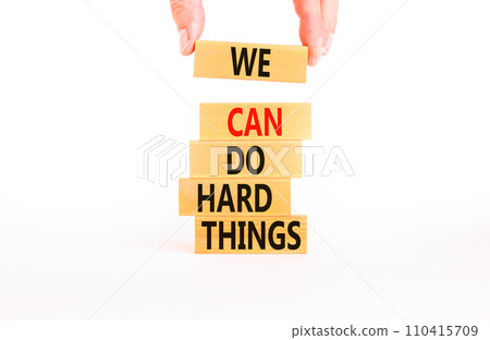 We can do hard things symbol. Concept words We can do hard things on wooden blocks. Beautiful white table white background. Businessman hand. Business, we can do hard things concept. Copy space. We can do hard things symbol. Concept words We can do hard things on wooden blocks. Beautiful white table white background. Businessman hand. Business, we can do hard things concept. Copy space. 110415709