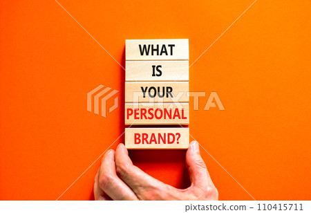 What is your personal brand symbol. Concept words What is your personal brand on wooden blocks. Beautiful orange background. Businessman hand. Business what is your personal brand concept. Copy space. 110415711