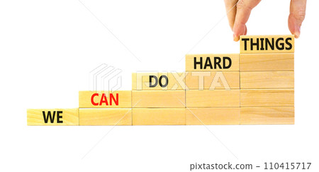 We can do hard things symbol. Concept words We can do hard things on wooden blocks. Beautiful white table white background. Businessman hand. Business, we can do hard things concept. Copy space. 110415717