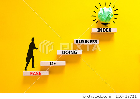 Ease of doing business index symbol. Concept words Ease of doing business index on wooden blocks. Beautiful yellow table yellow background. Business, ease of doing business index concept. Copy space. 110415721
