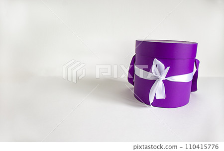 Round gift box on a beautiful white background. Copy space. Concept. Web banner. Round gift box on a beautiful white background. Copy space. Concept. Web banner. 110415776
